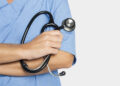 Doctor&rsquo;s hand holding a stethoscope closeup
