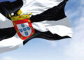 Rear view of Ceuta city flag waving in the wind on a clear day. Ceuta is a Spanish autonomous city on the north coast of Africa. Selective focus