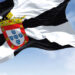 Rear view of Ceuta city flag waving in the wind on a clear day. Ceuta is a Spanish autonomous city on the north coast of Africa. Selective focus